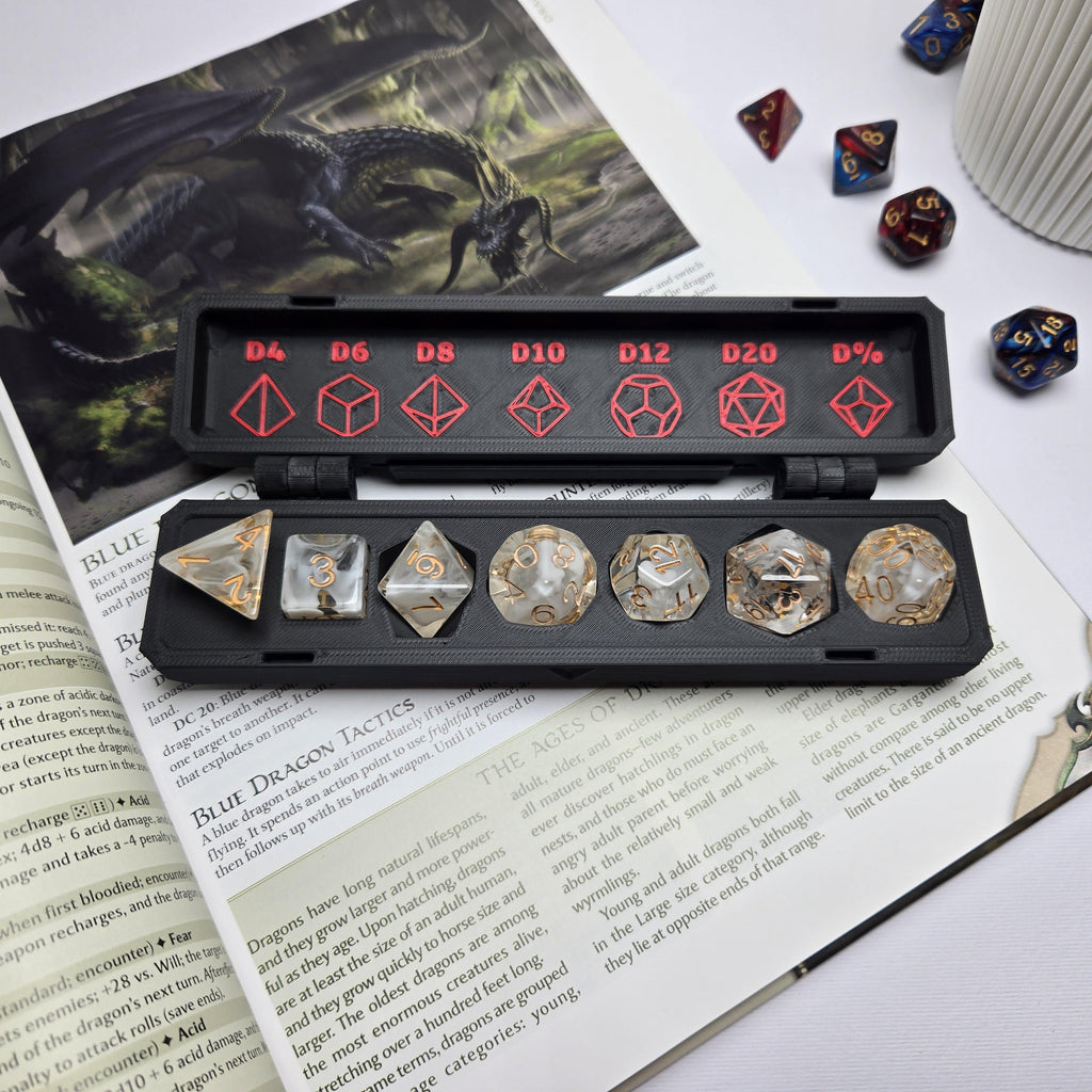Set of dice with a black carrying case on an open book