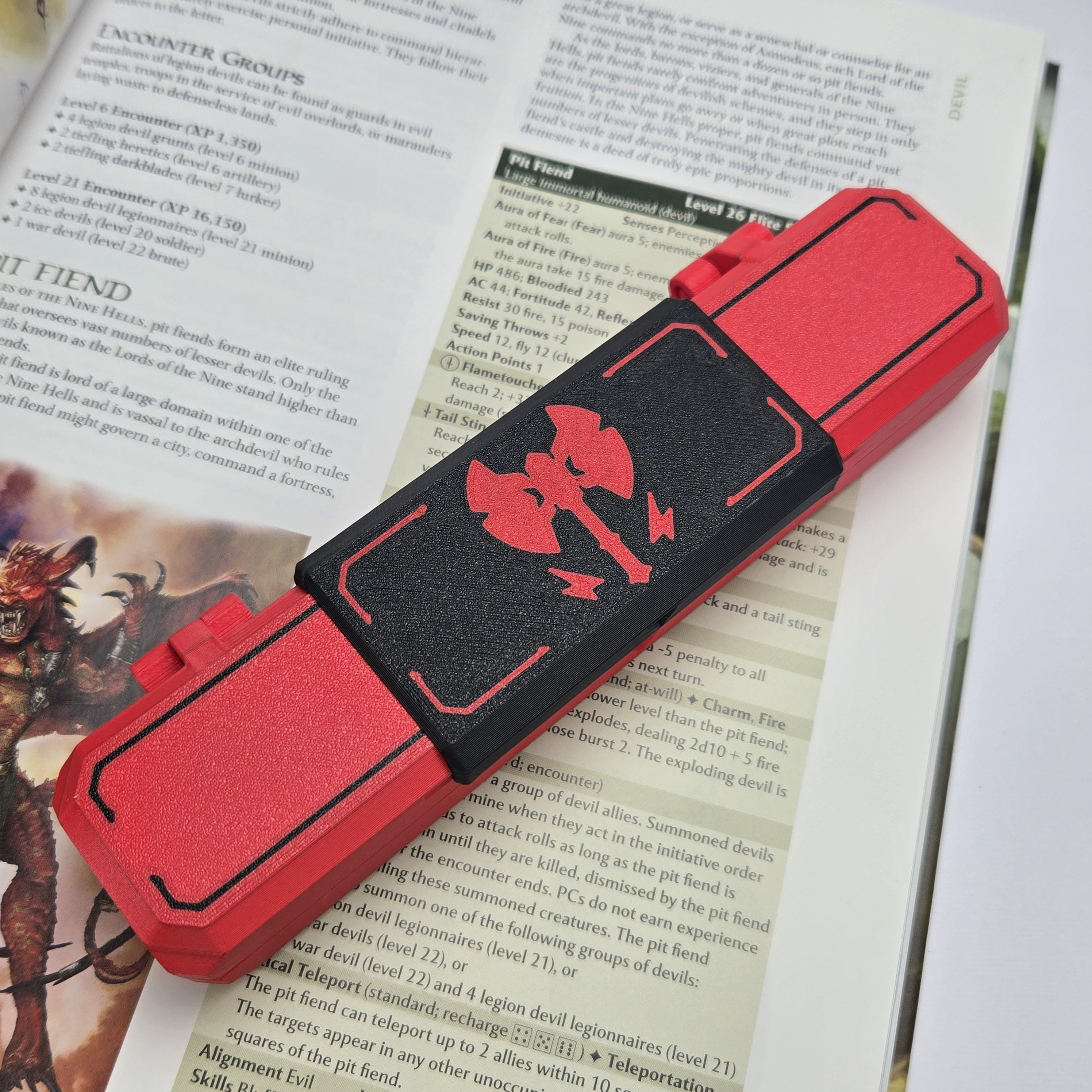 Red and black case with a red symbol on top of a book